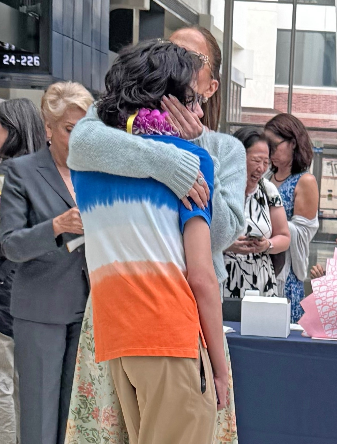 Jennifer Lopez tearfully embracing her son Max at his high school graduation.
