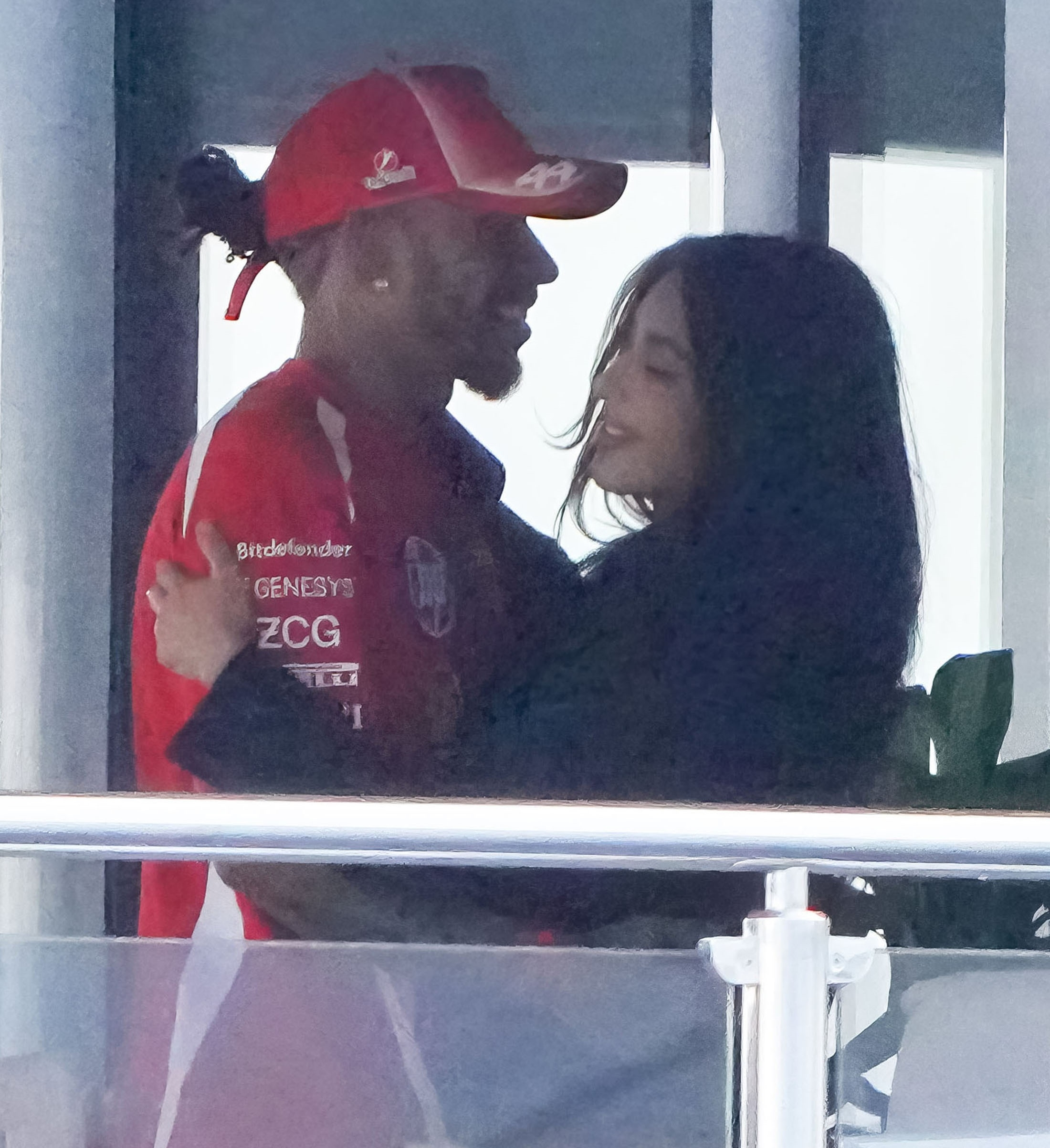 Kim Kardashian and Lewis Hamilton embracing on a yacht.