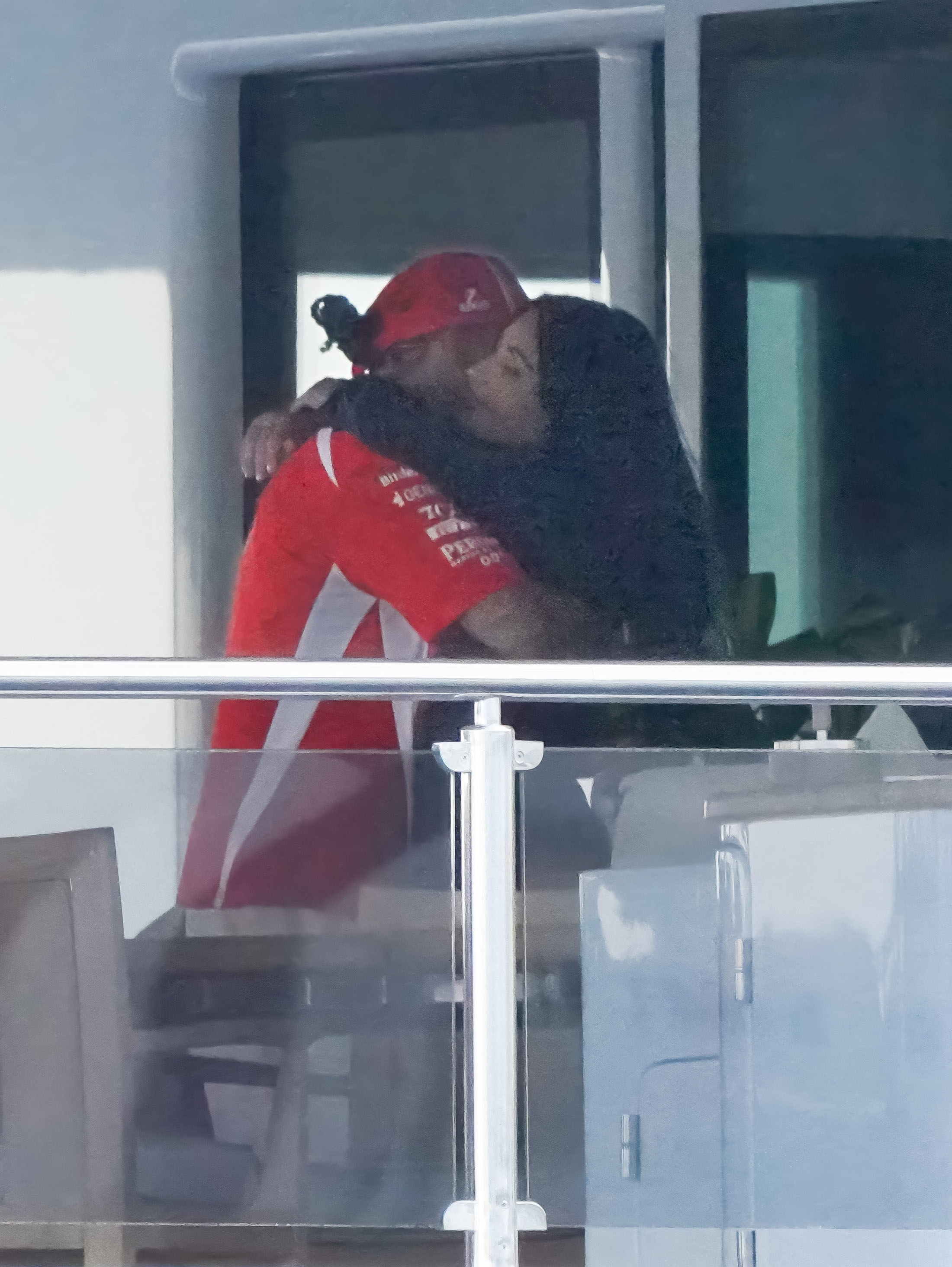 Kim Kardashian and Lewis Hamilton embracing.