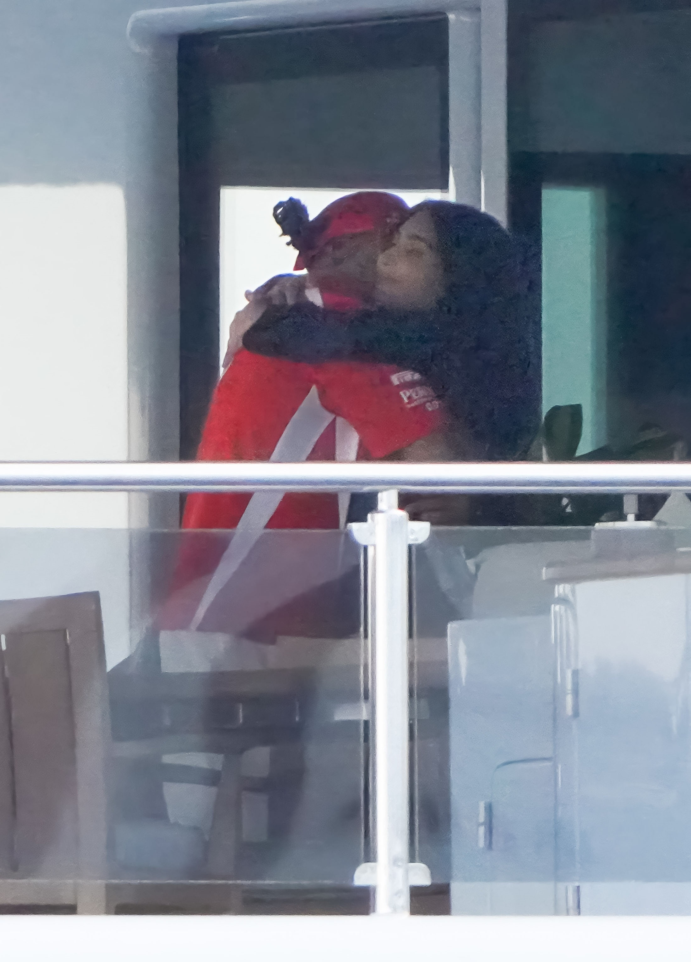 Kim Kardashian embracing Lewis Hamilton on a yacht.