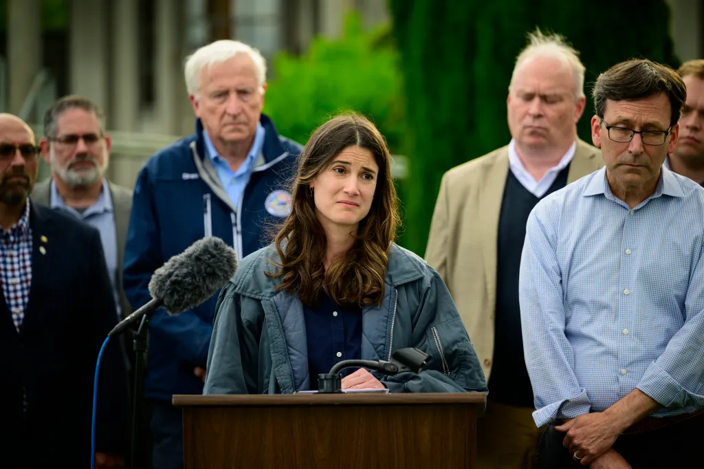U.S. Rep. Marie Gluesenkamp Perez speaking at a press conference, surrounded by men.