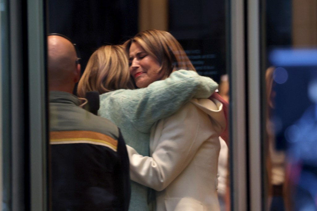 Savannah Guthrie , in a white coat ,hugging a Jenna Bush Hager, in a green coat, with tears visible on her face.