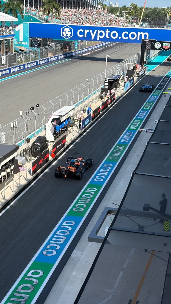 Two Formula 1 race cars on the track with a 