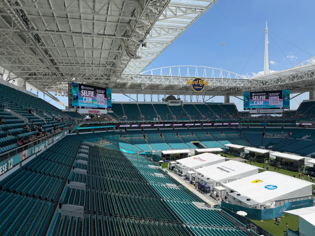A high-angle view of the Hard Rock Stadium stands, mostly empty, with the 