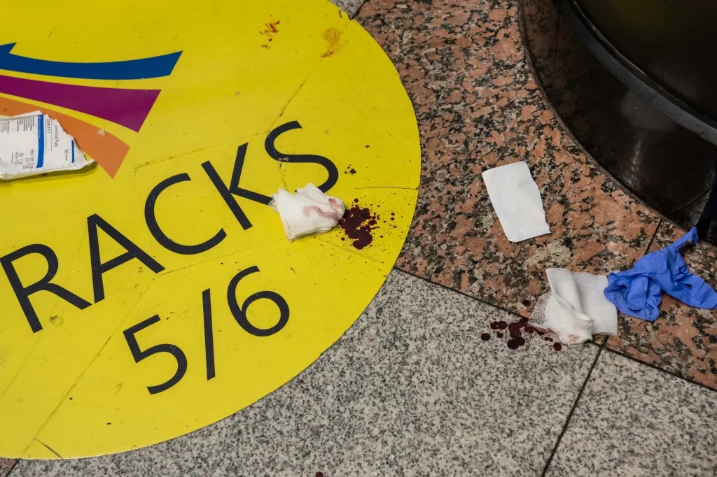 Blood and used medical items on the floor at Penn Station after a stabbing incident.