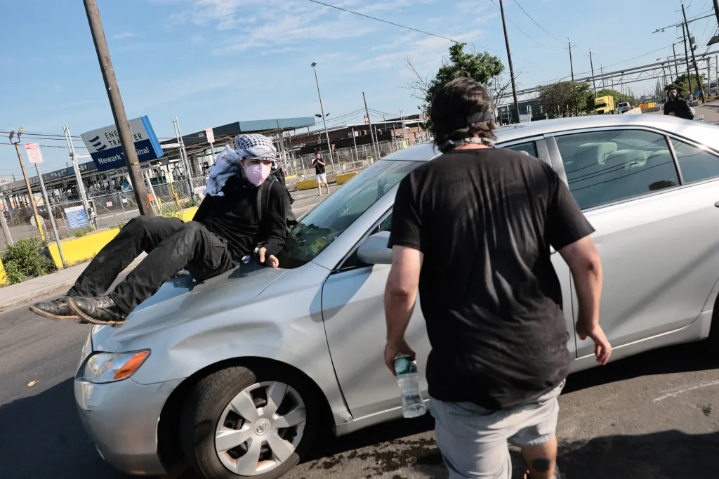Protesters block a vehicle from leaving the Delaney Hall Immigration Detention Center in Newark.