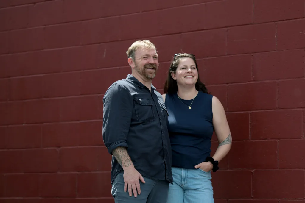 U.S. Senate candidate Graham Platner and his wife Amy Gertner sharing a moment at a campaign event.