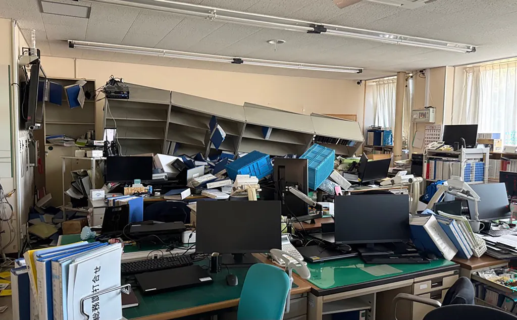 Office supplies and furniture is scattered in a room at the Hashikami Town Hall after an earthquake.