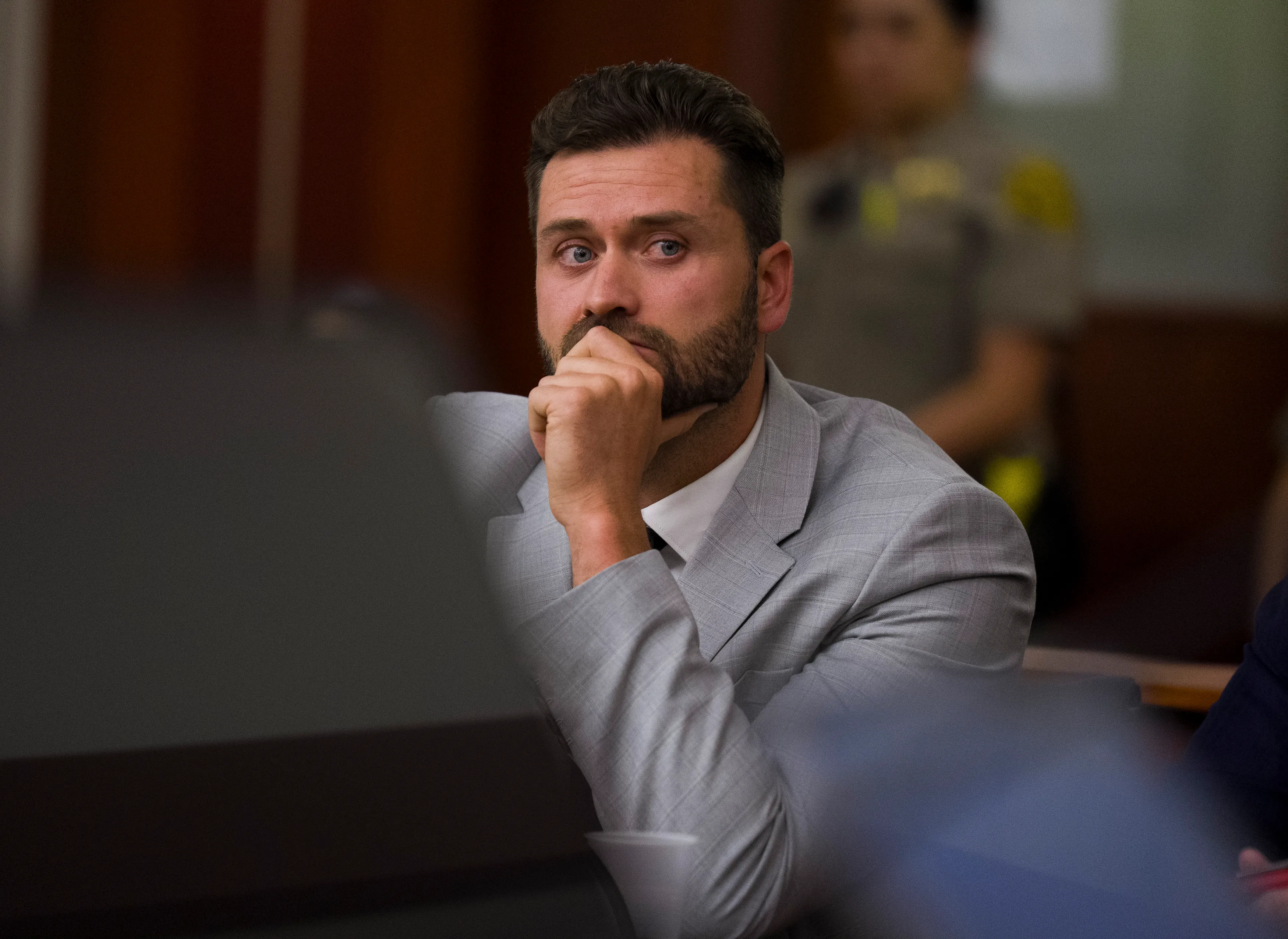 Dakota Mortensen in a gray suit appearing during a protective order hearing in Salt Lake City.