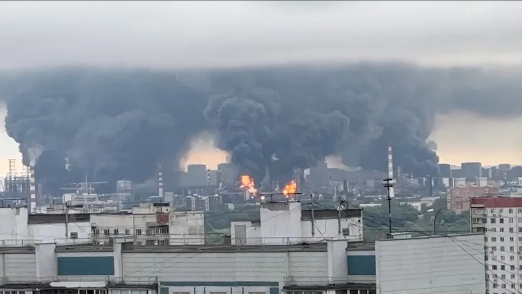 Thick plumes of smoke with flames rise from an oil refinery in Moscow, Russia, June 18, 2026 in this screengrab taken from a social media video.