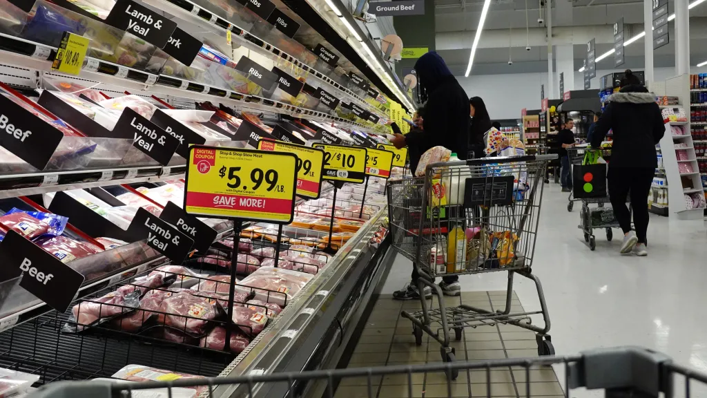 Shoppers at a grocery store stocking up on meat and other supplies before a winter storm.