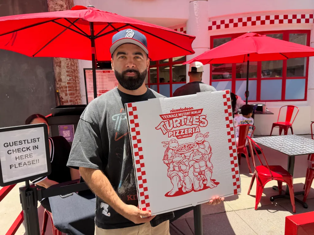 Man holding a pizza box.