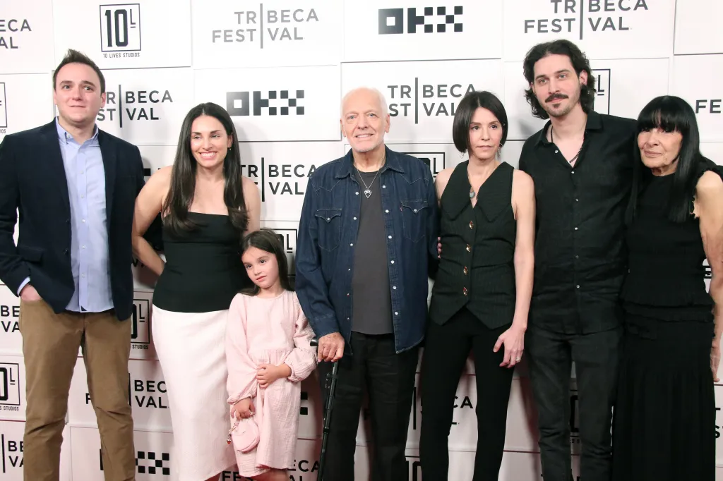 Peter Frampton and his family, including a young girl, pose together on the red carpet at the Tribeca Festival premiere of 
