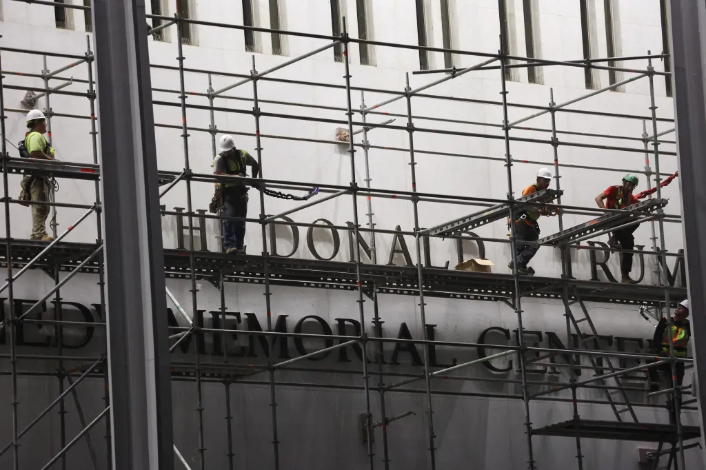 Workers build scaffolding near the signage outside the Kennedy Center to remove President Trump's name on June 13, 2026.