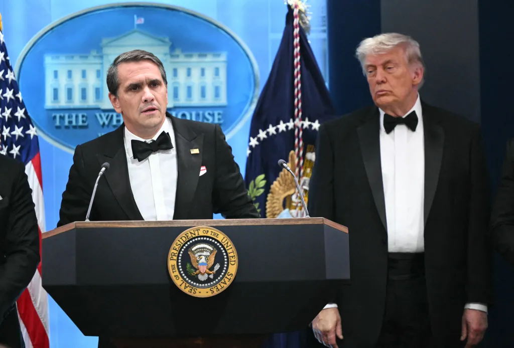 Donald Trump watches as acting Attorney General Todd Blanche speaks at a White House press briefing.