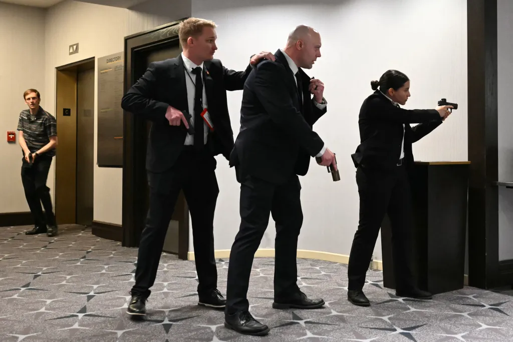 Agents drawing their guns after loud bangs were heard during the White House Correspondents' dinner.