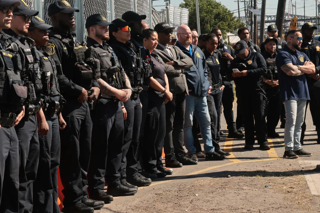 Police officers standing in a row outside Delaney Hall Detention Facility in Newark.