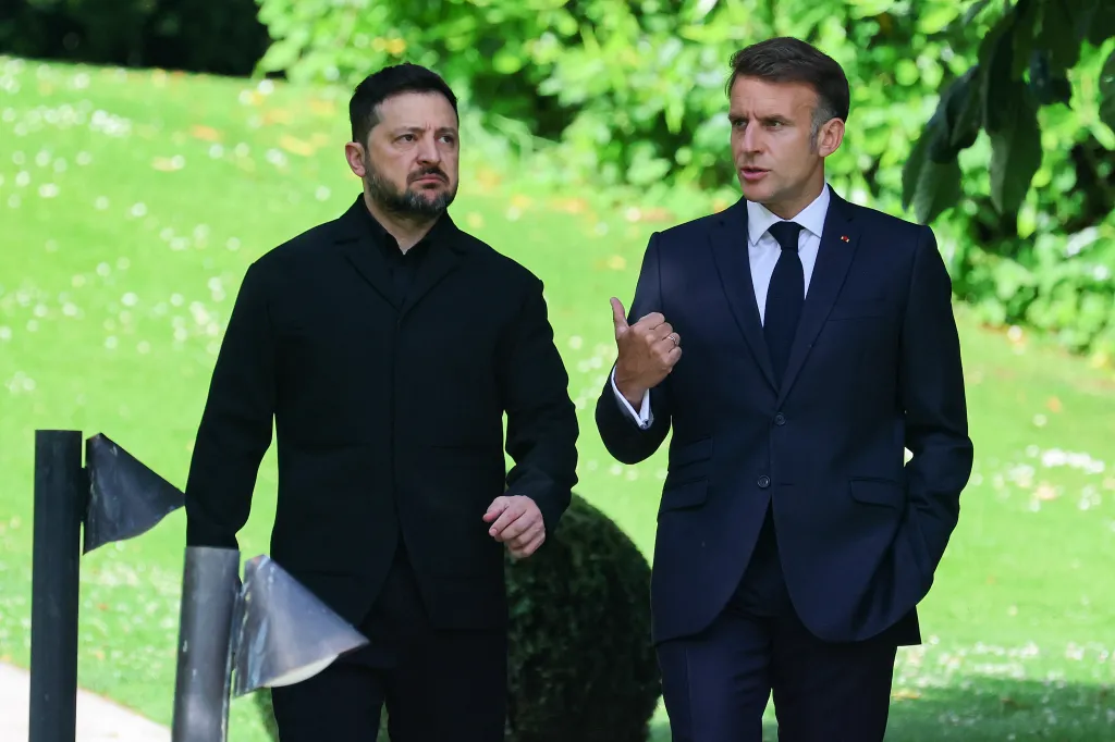 France's President Emmanuel Macron (R) greets Ukraine's President Volodymyr Zelensky ahead of the working session with G7 leaders and Ukraine during the G7 summit, in Evian, eastern France, on June 16, 2026.