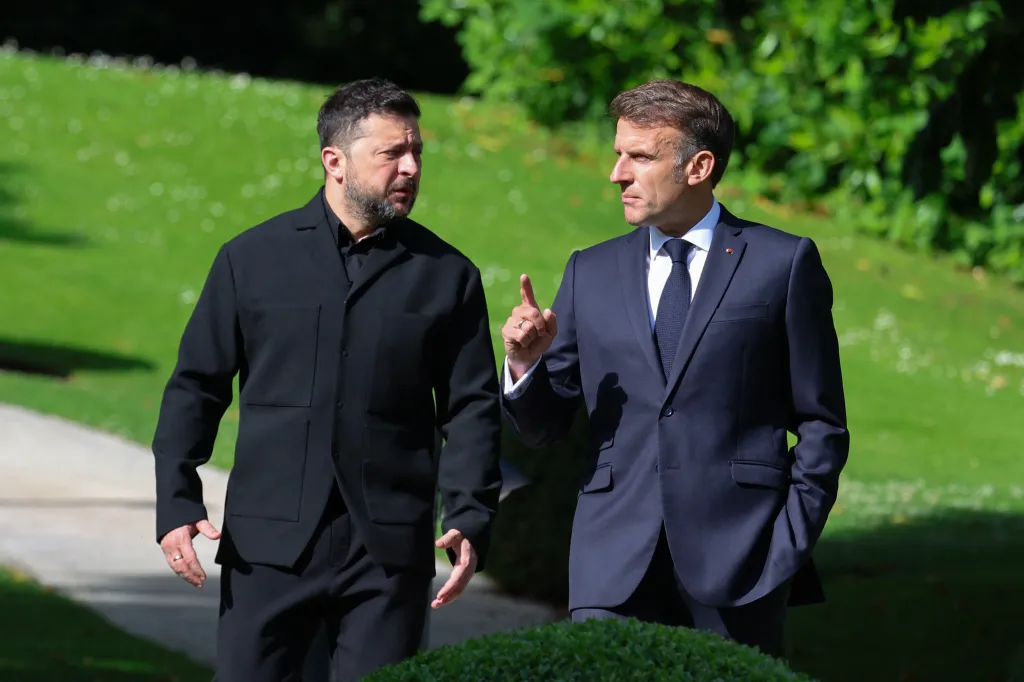 France's President Emmanuel Macron (R) greets Ukraine's President Volodymyr Zelensky ahead of the working session with G7 leaders and Ukraine during the G7 summit, in Evian, eastern France