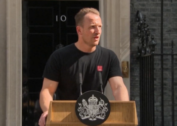 He Is British, Mysterious and Has Outlasted 5 Prime Ministers: Meet ‘Hot Podium Guy.’