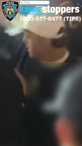 Blurred image of a person, identified by NYPD Crime Stoppers, wanted for assault and robbery.