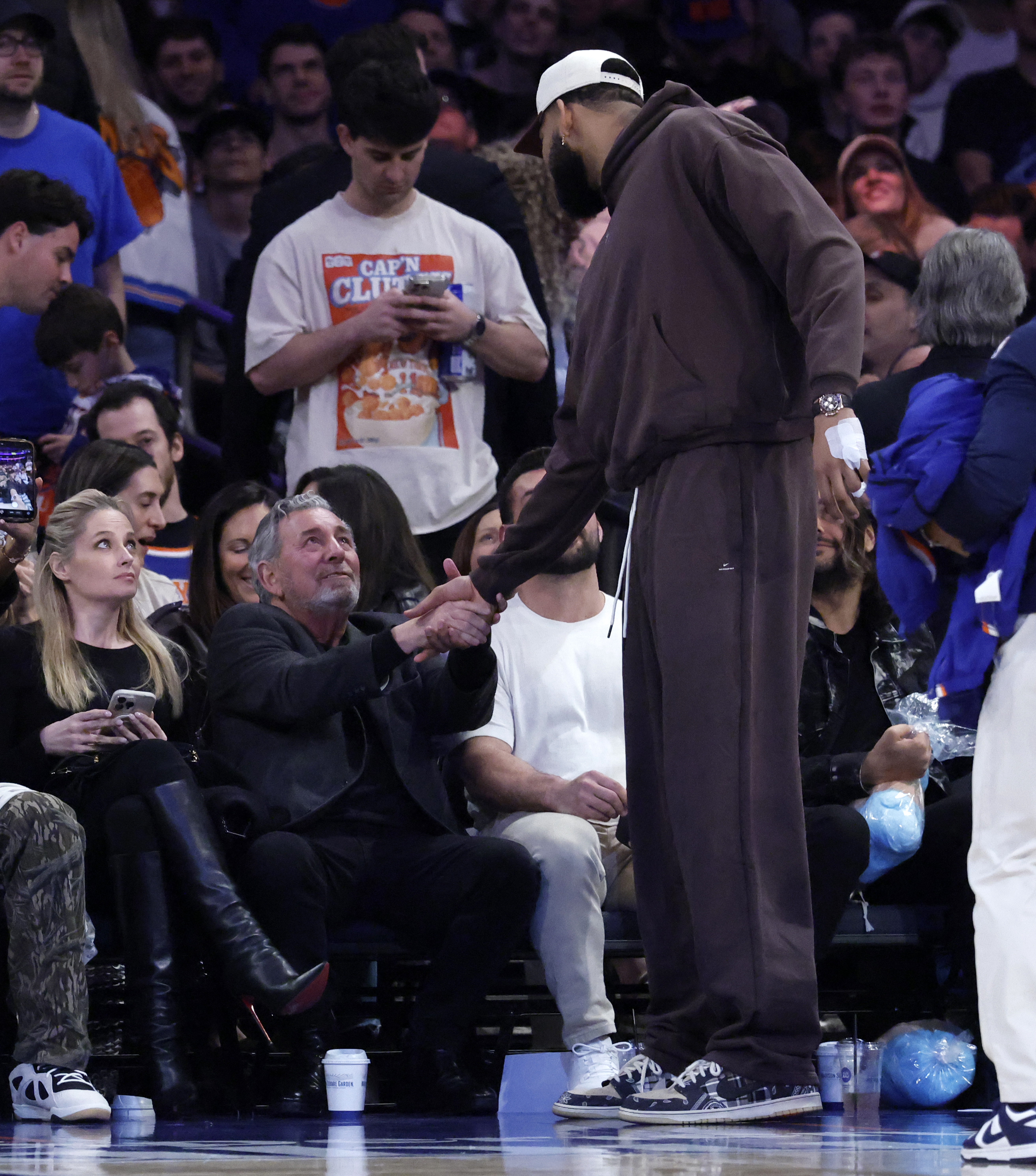 Knicks owner James Dolan shaking hands with player Karl-Anthony Towns.