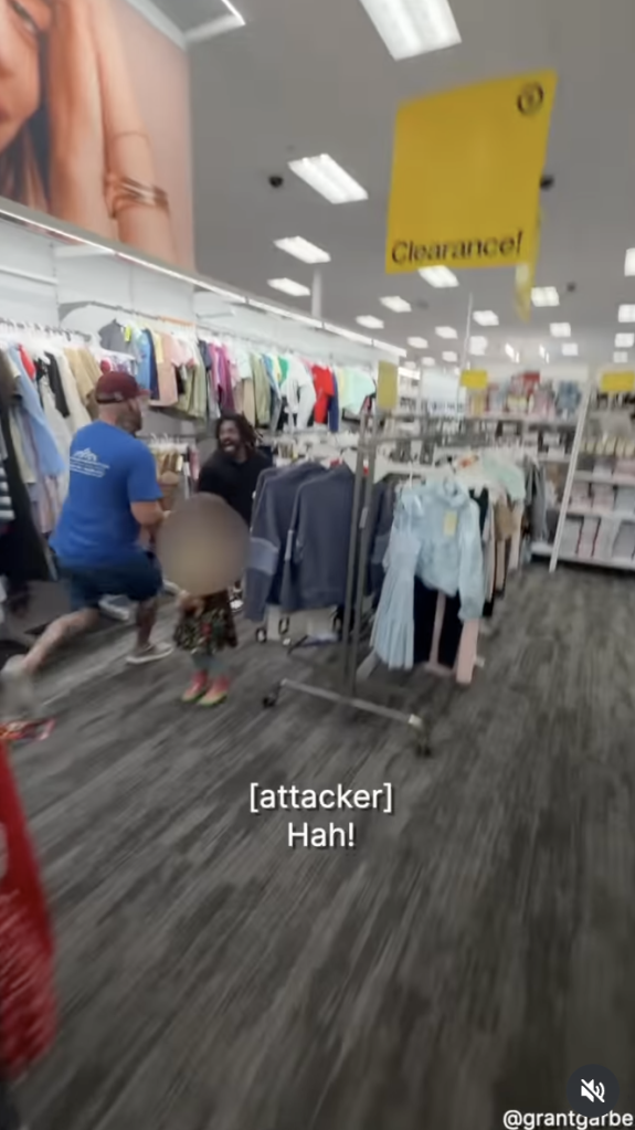 Man in a blue shirt grappling with an attacker while a woman stands nearby in a Target store.