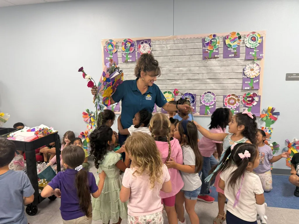 Principal Dr. Zickafoose surrounded by students in a classroom, celebrating Principals’ Appreciation Day.