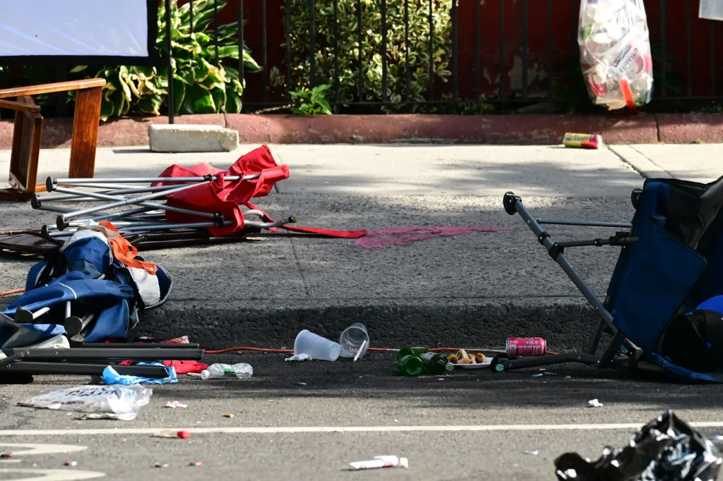 Debris from a party, including folding chairs, plastic cups, and bottles, on a street where Emanuel Spencer was fatally shot.