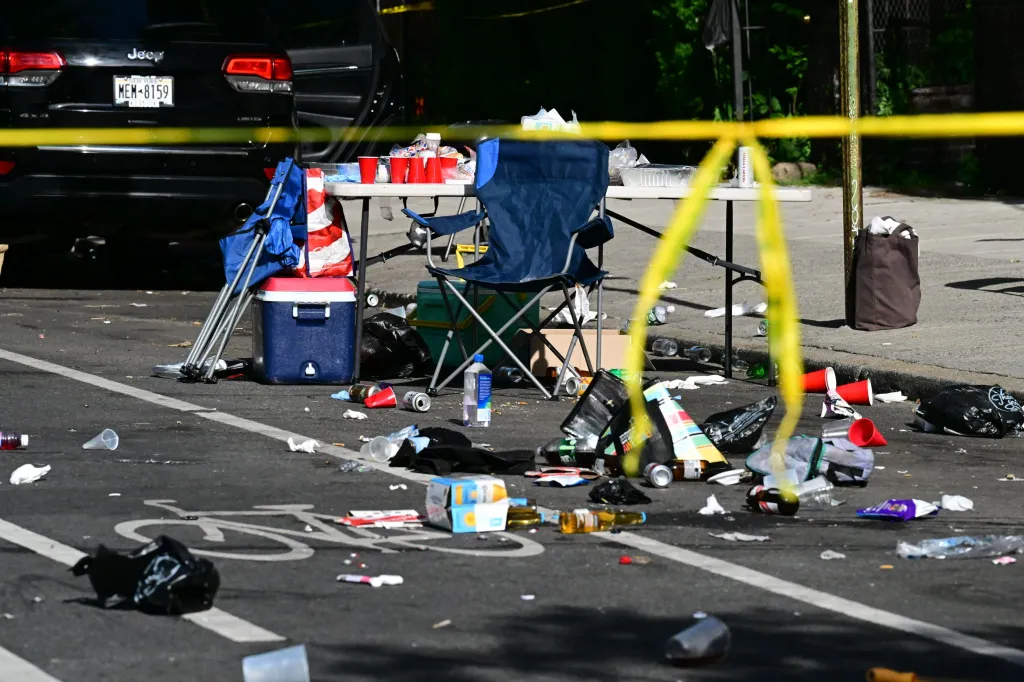 Crime scene with yellow tape and party debris on Lincoln Road where Emanuel Spencer was fatally shot.