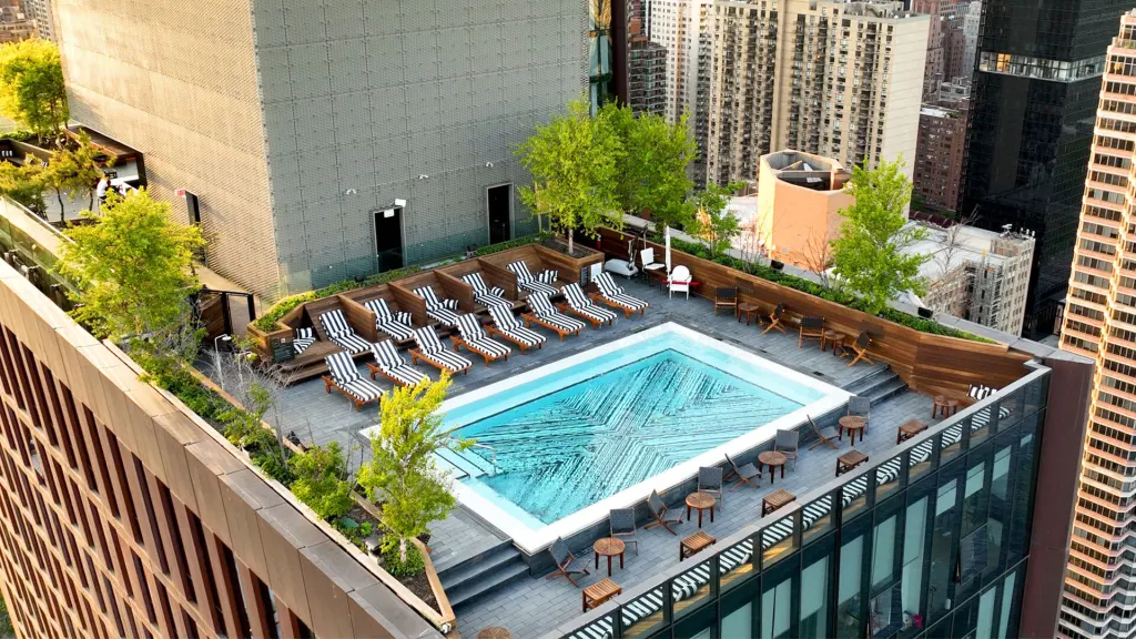 In Murray Hill, The Copper at 626 First Avenue offers AYRE, a members-only rooftop pool club sitting 470 feet above street level with panoramic views, cabanas, and grilling areas, open to both residents and outside members at annual fees of $2,800 and $3,250 respectively.