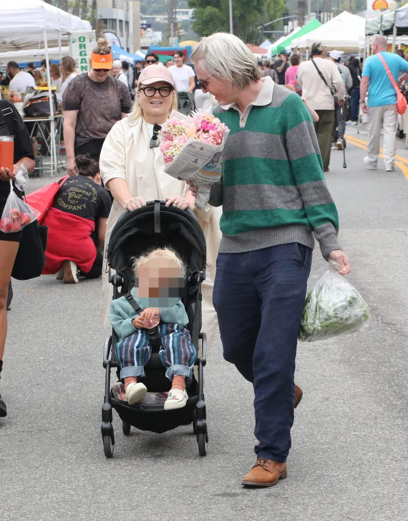 Sia and Erik Anders Lang with their child in a stroller at the Studio City Farmers Market.