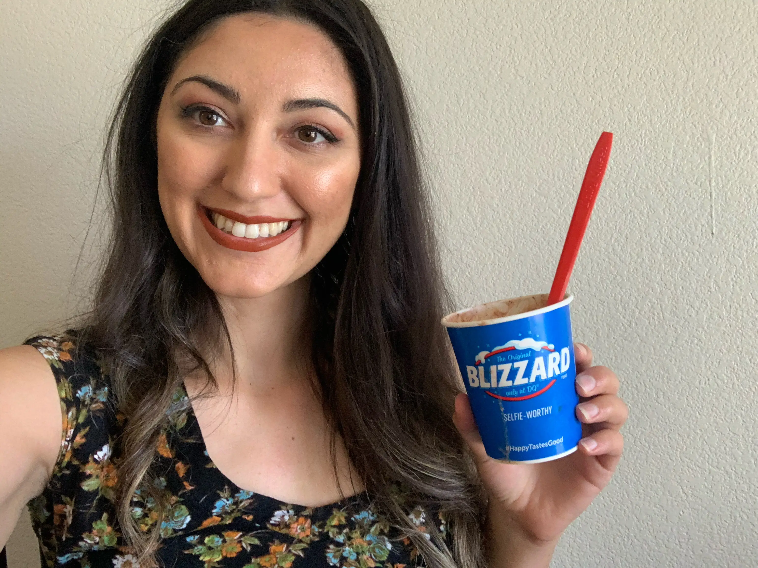 Woman smiling, holding Dairy Queen Blizzard