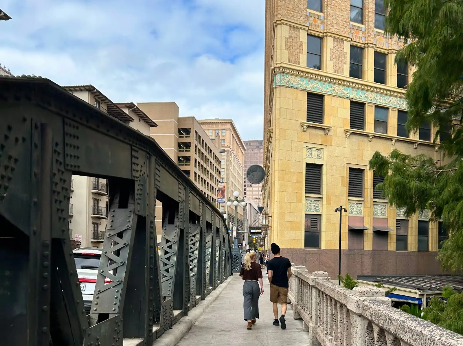 two people on the navarro bridge in san antonio