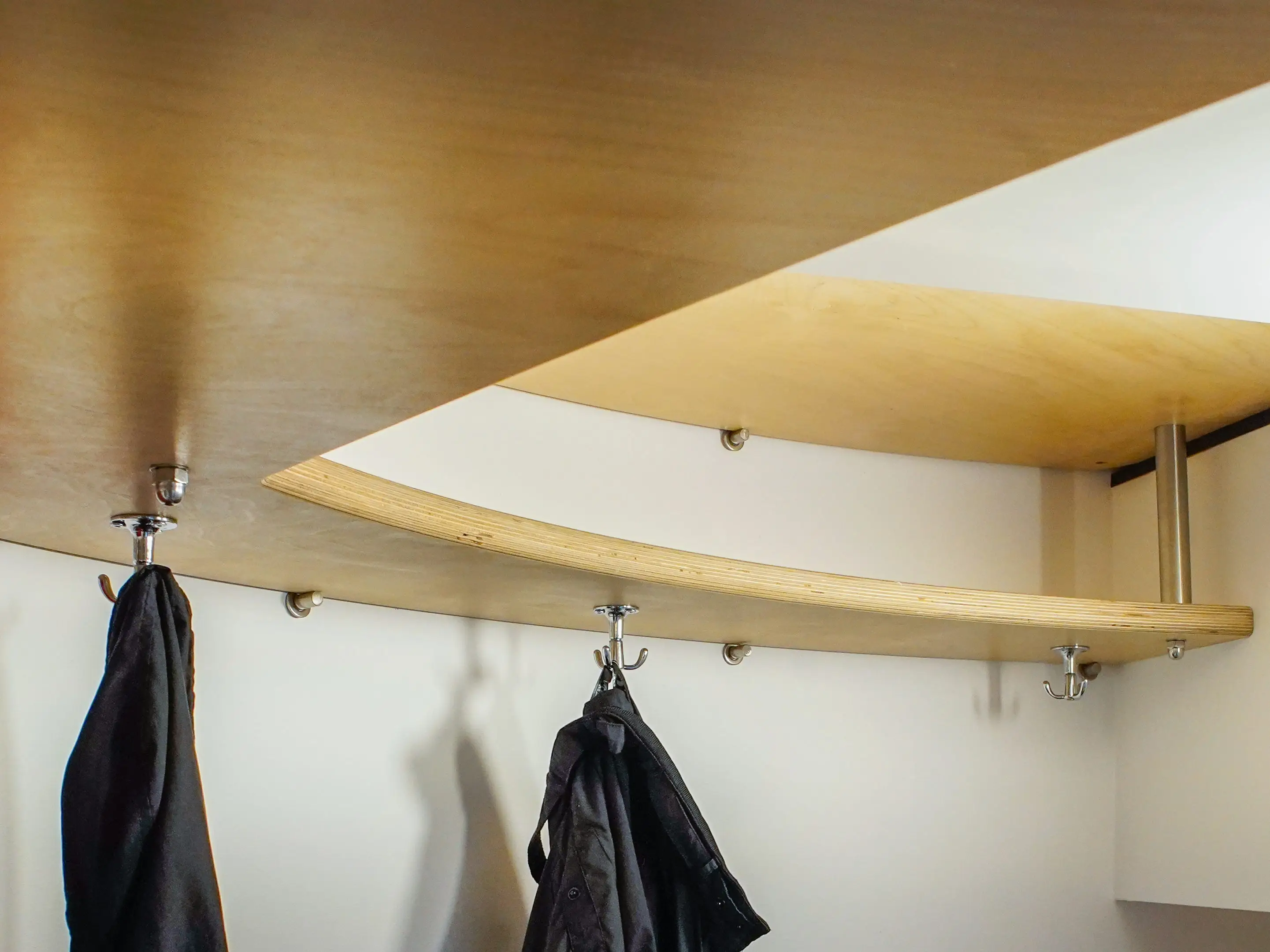 The author's coats hang in the Airbnb.
