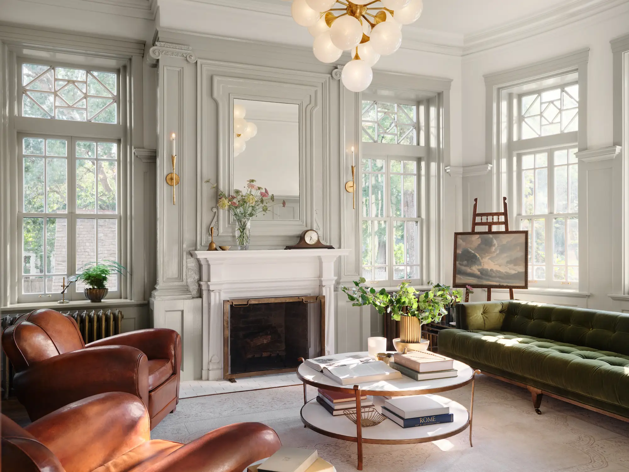 A living room with large windows and a fireplace.