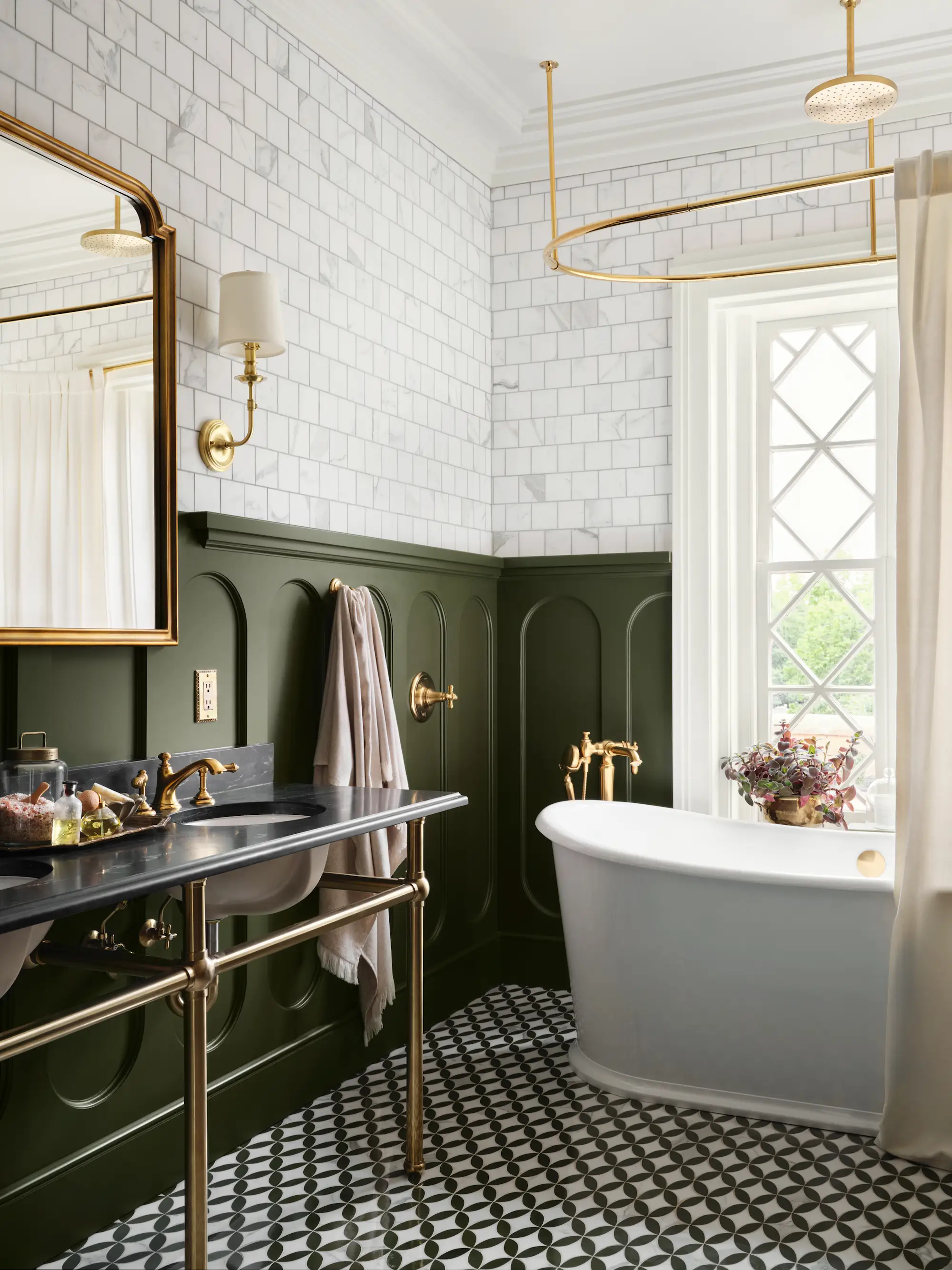 A bathroom with green walls and a large bathtub.