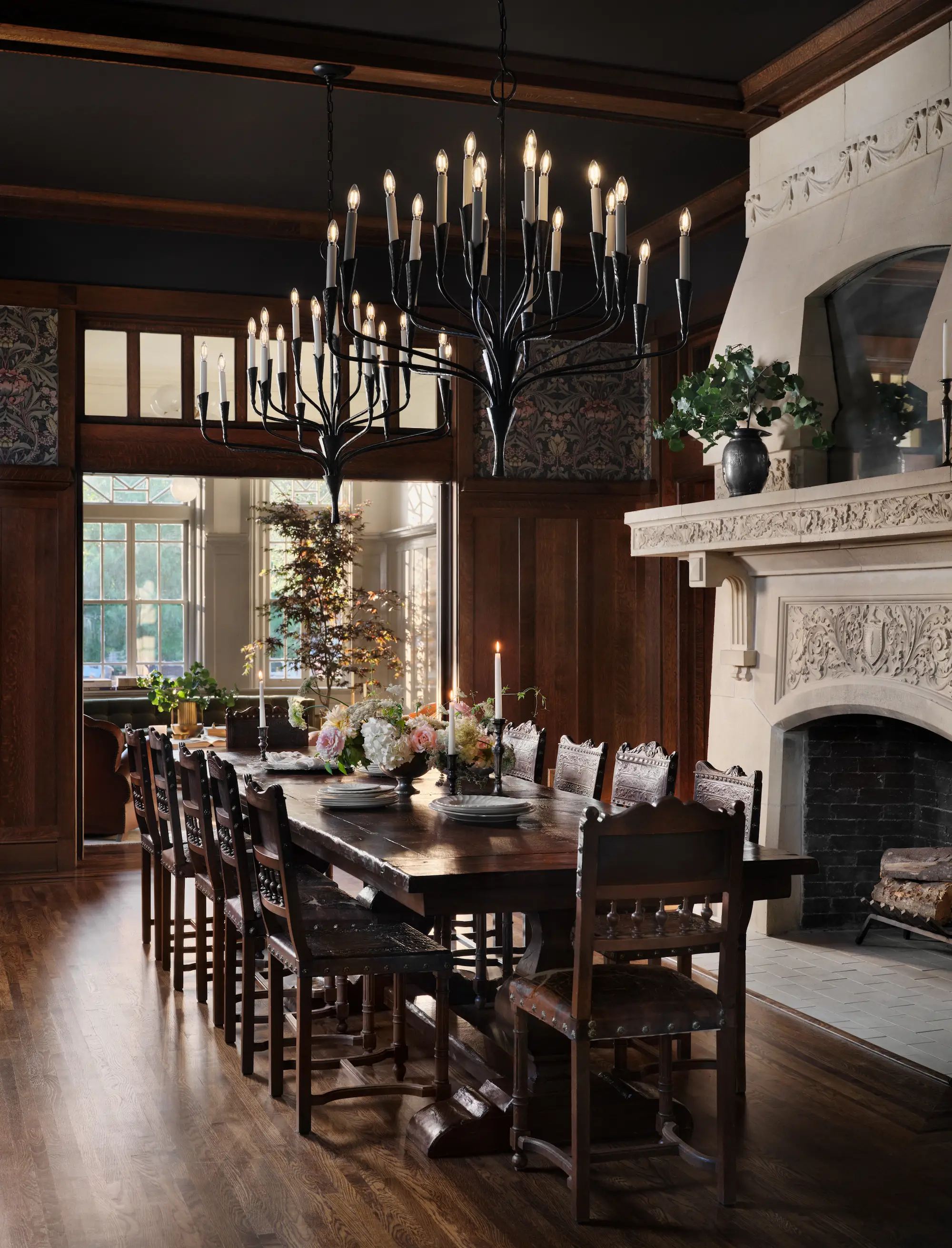 A dining room with mahogany walls and a white fireplace.