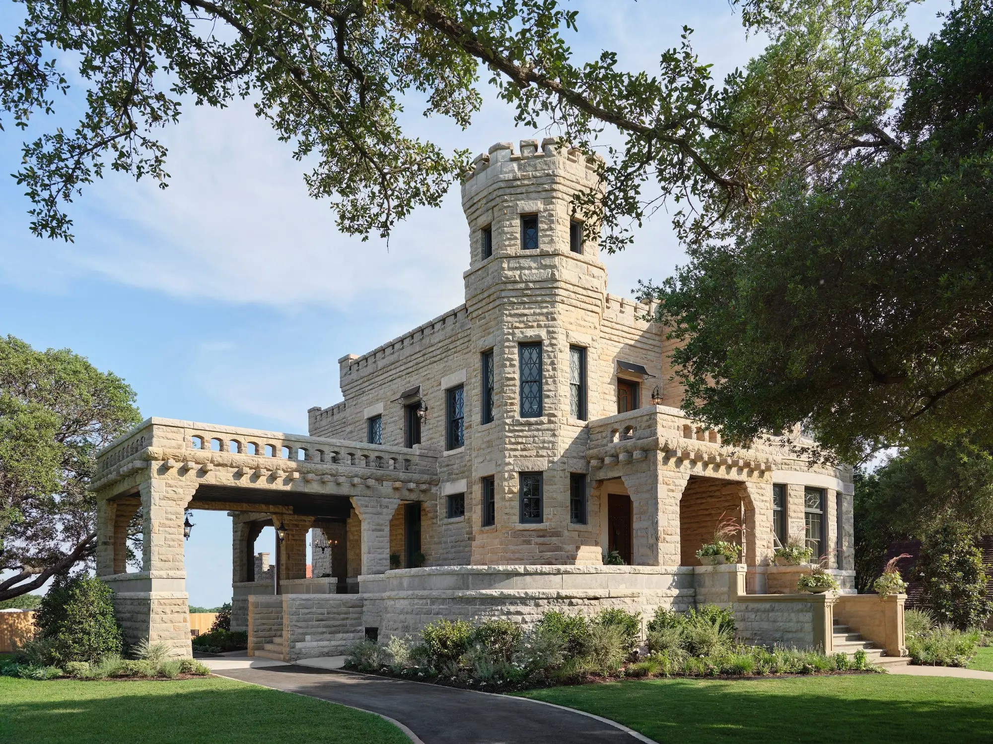 A castle sits on a lawn.