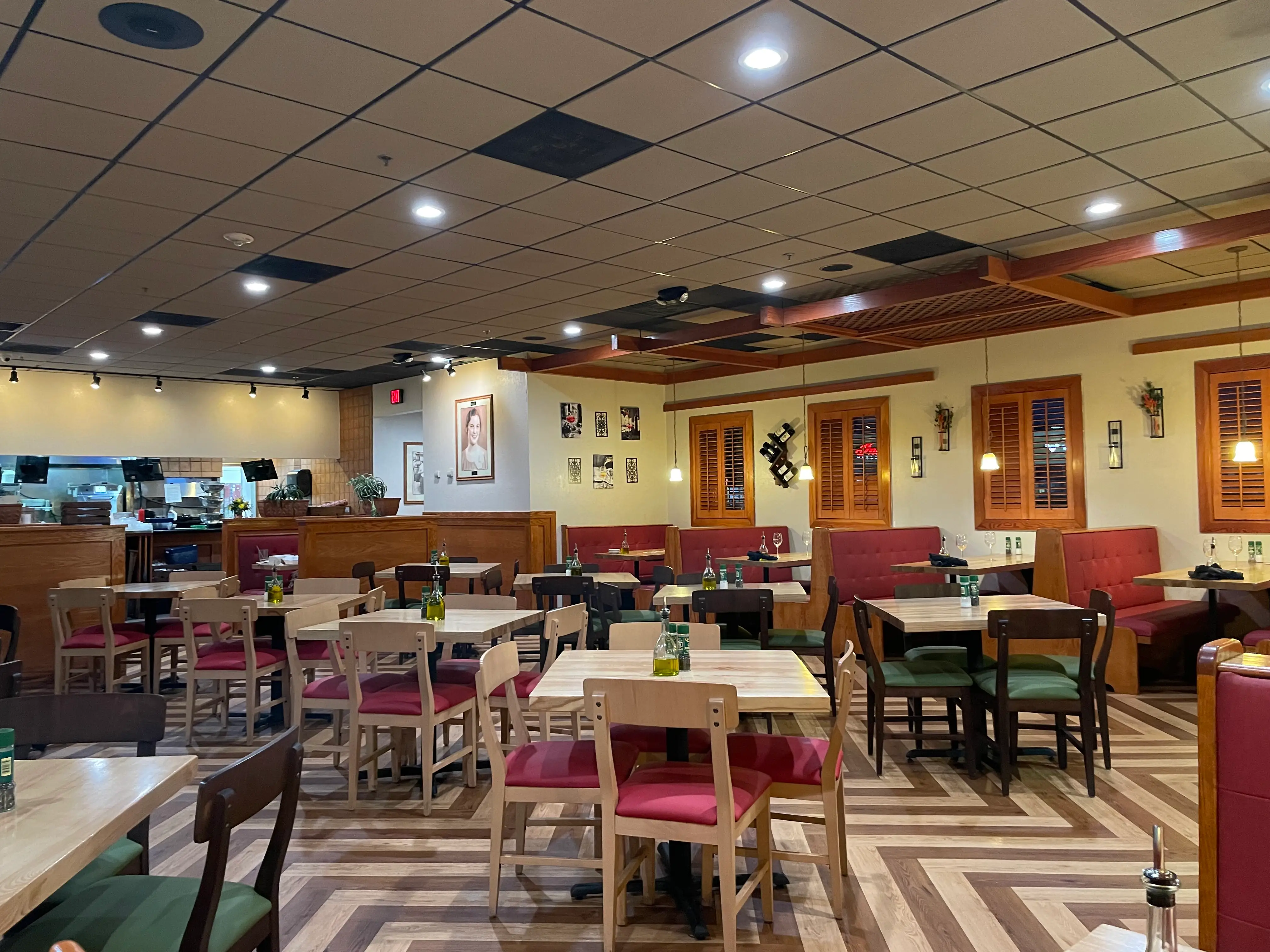 Mix of light and dark wooden seating and dimly lit dining area at Carrabba's