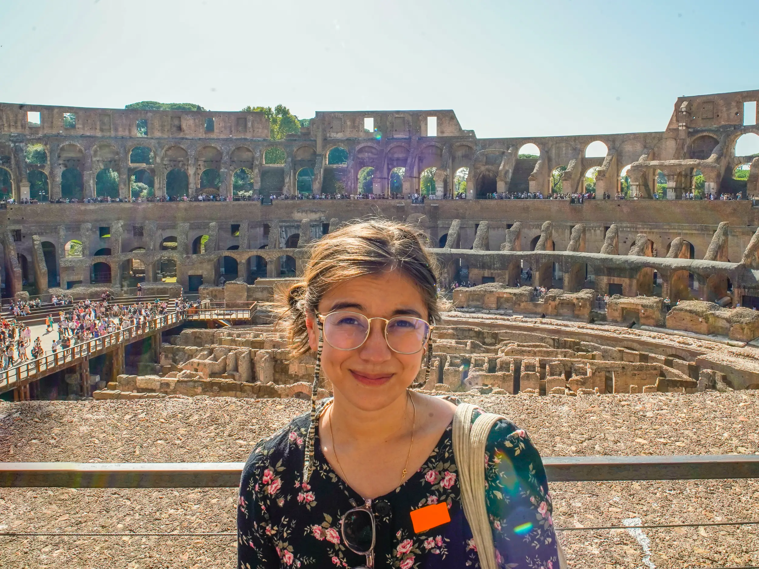 The author stands in front of the Colosseum in Rome