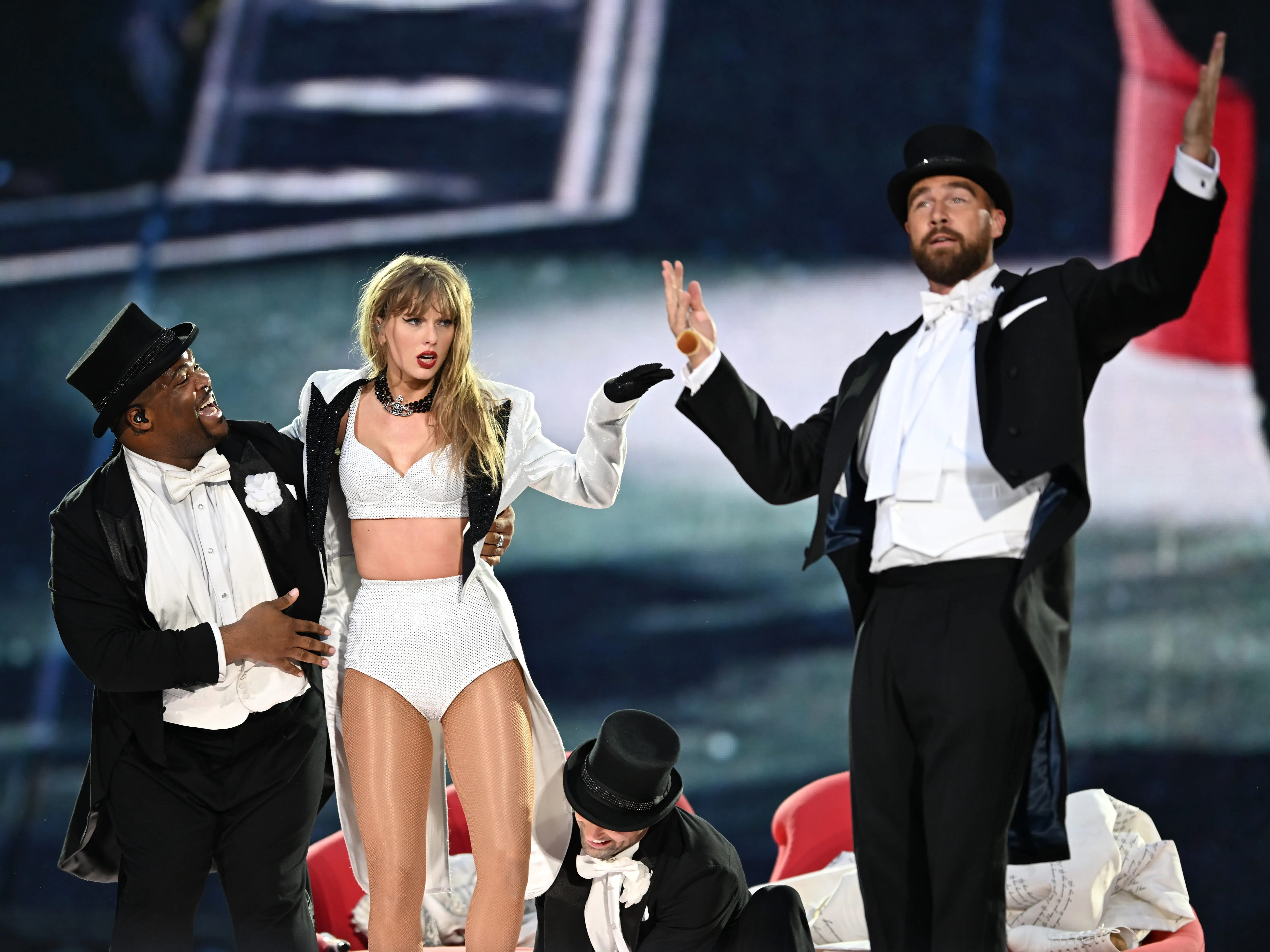 Taylor Swift is joined onstage by Travis Kelce (R), during 