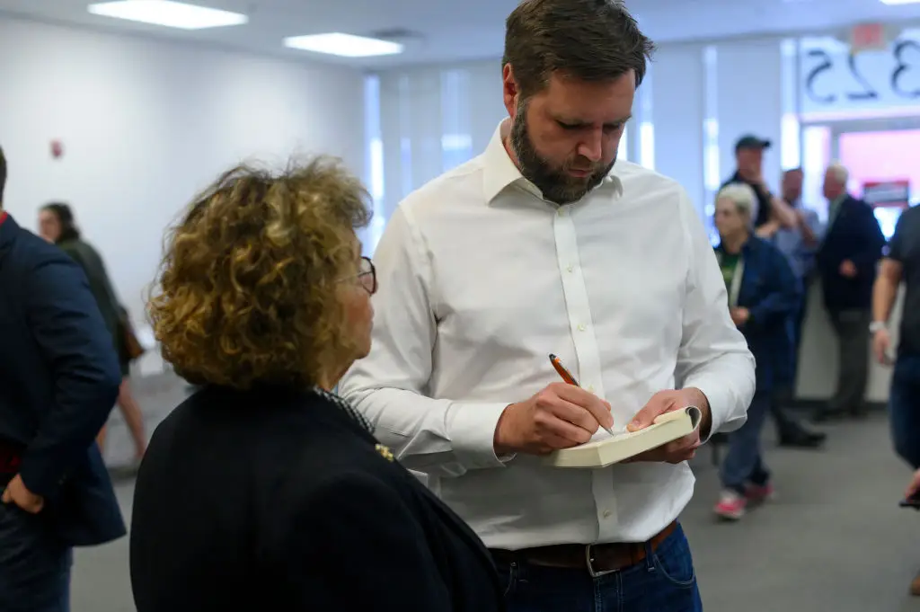 Vance signs a copy of 