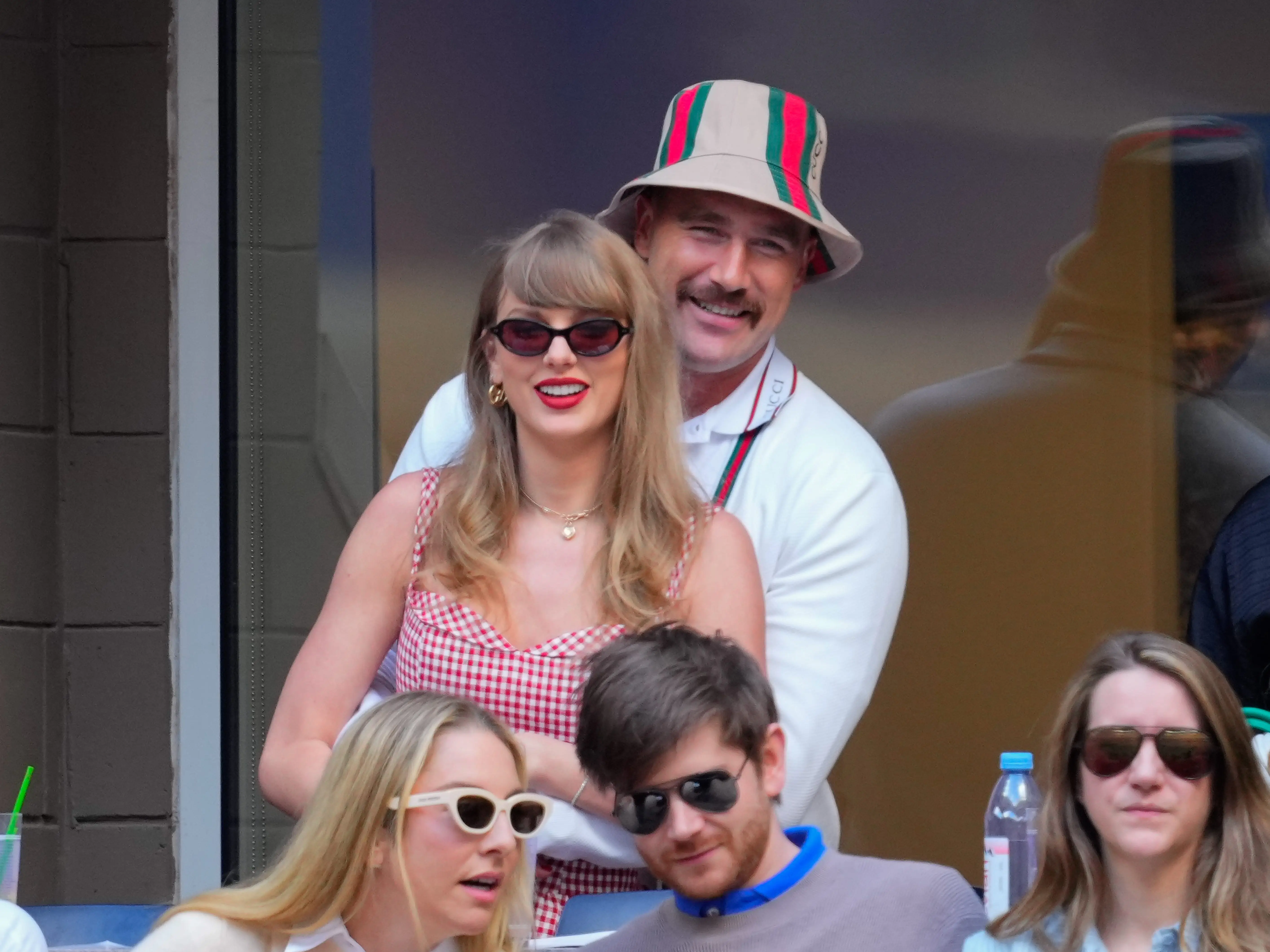 Travis Kelce hugging Taylor Swift from behind at the 2024 US Open Tennis Championships.