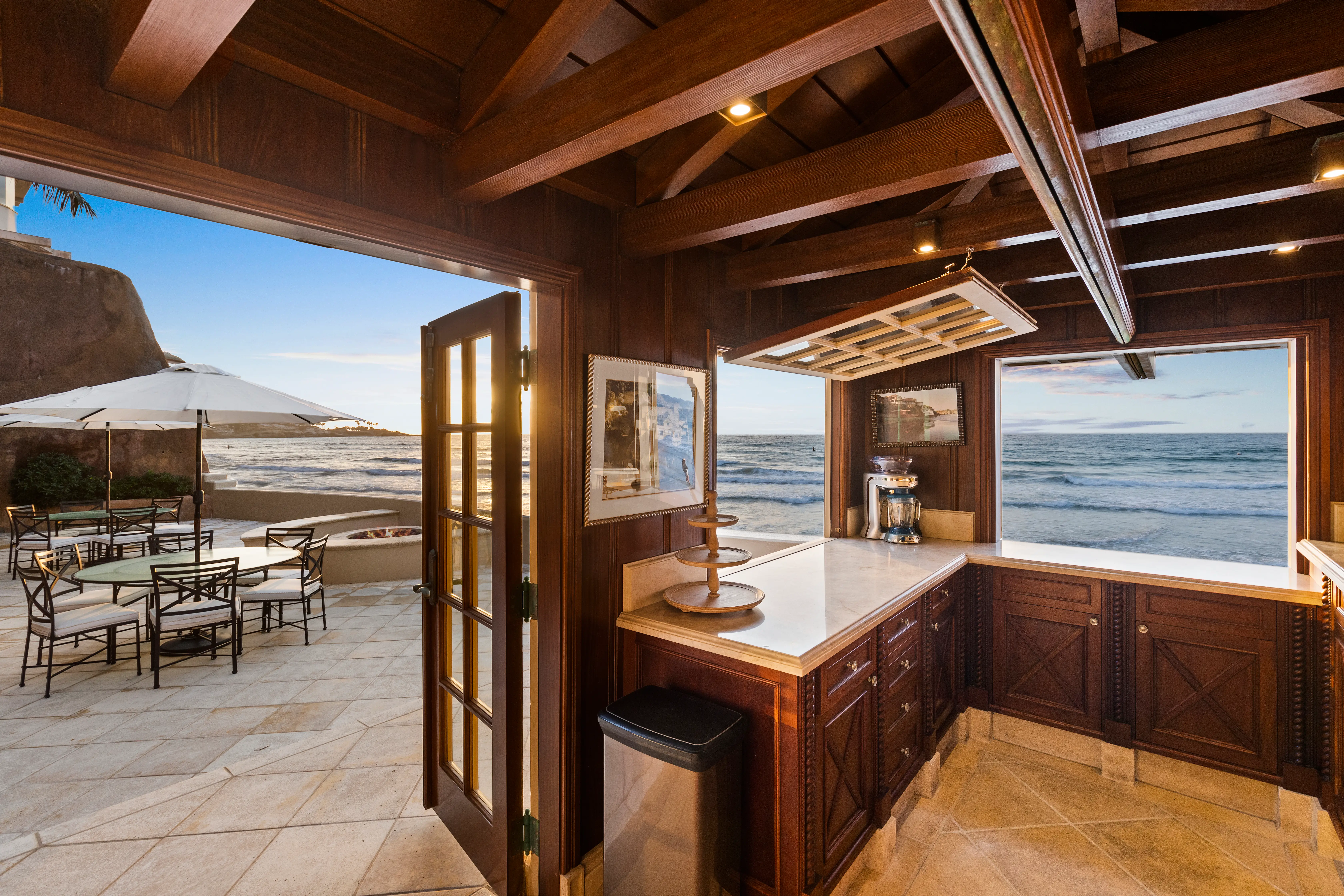 A door from the wood-panel bar room leading to an outdoor terrace at the Sand Castle mansion.