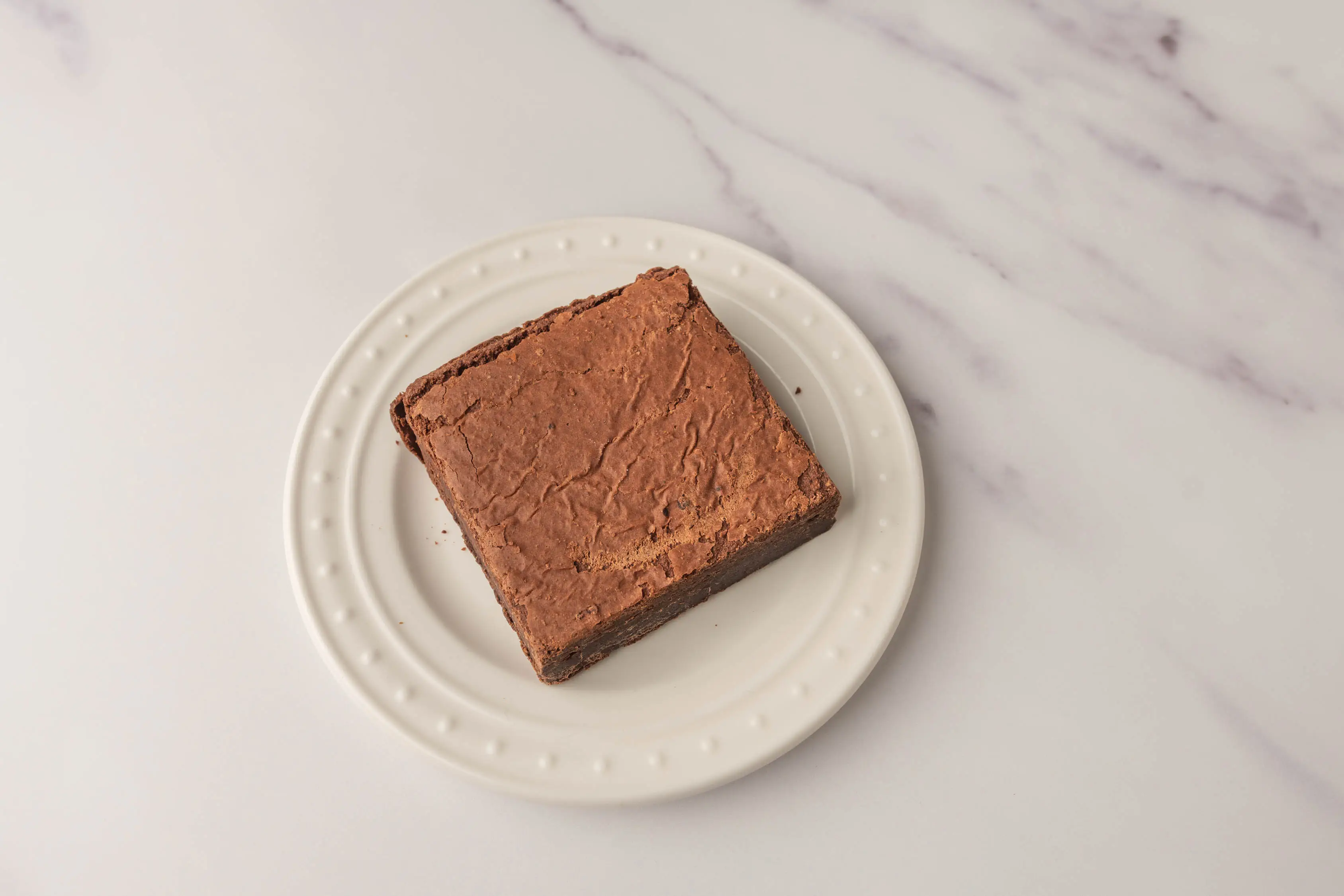 Square brownie from Wholefoods on white plate