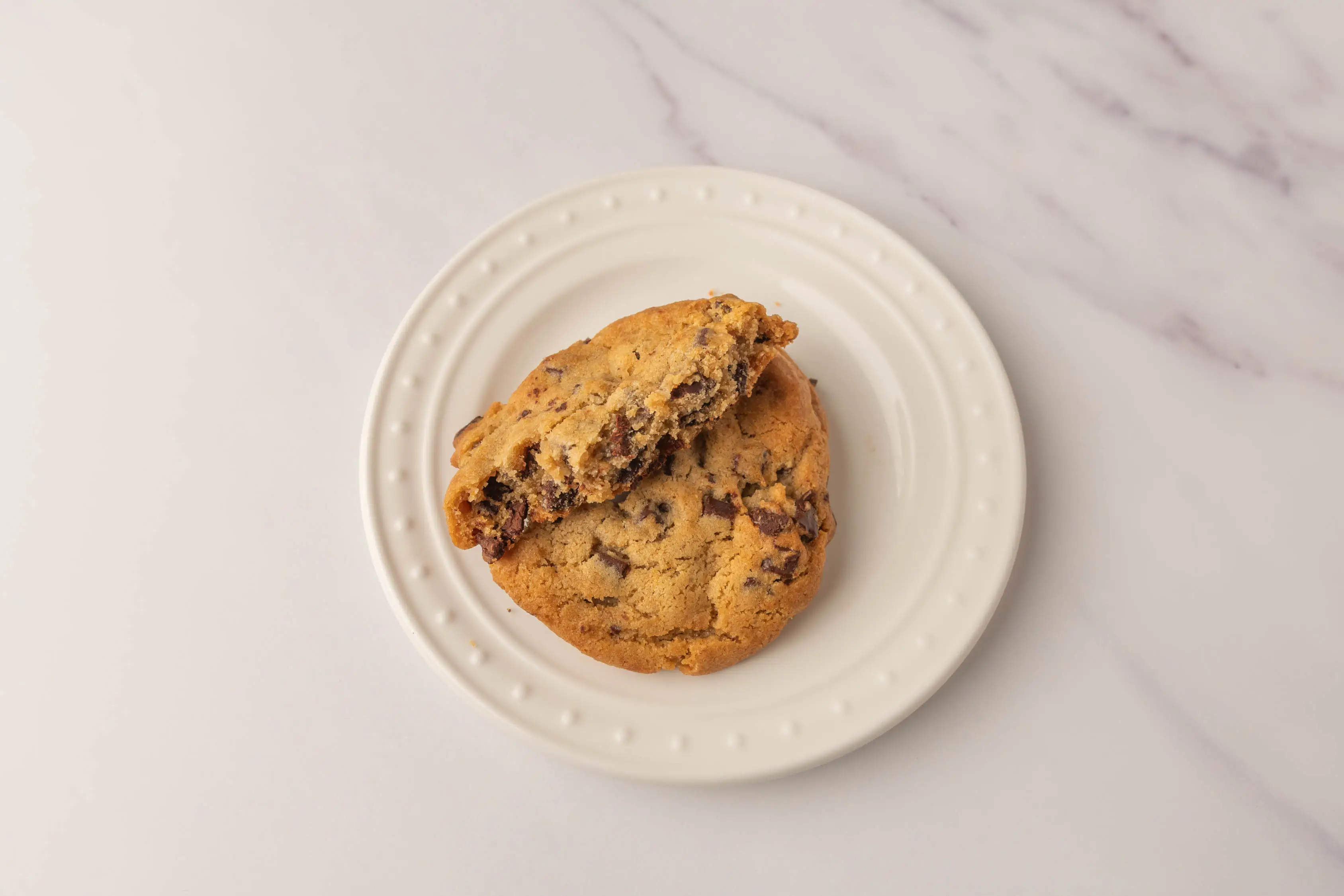 Chocolate chunk cookie half on top of another chocolate chunk cookie from Wholefoods