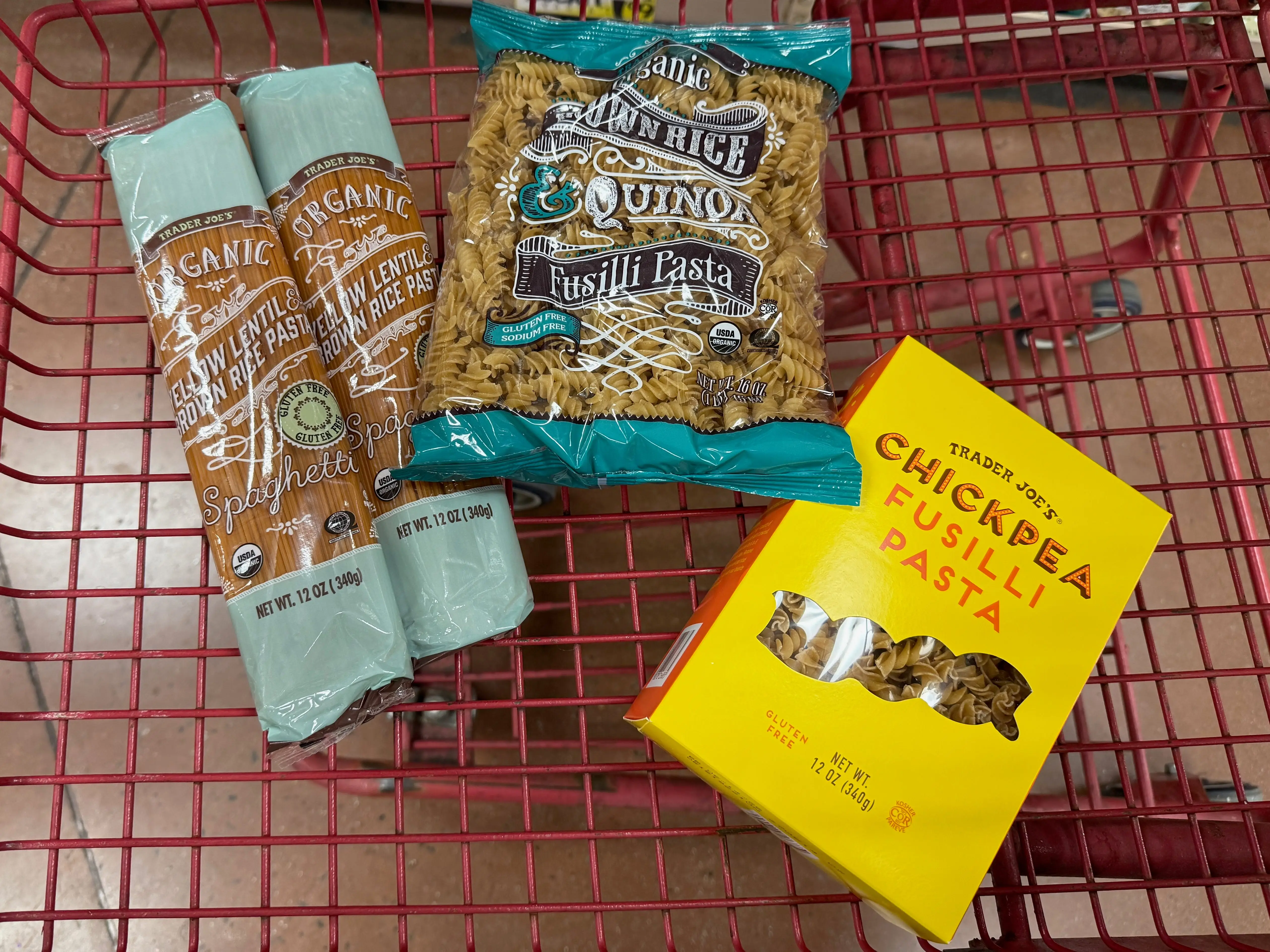 packages of protein pasta in a cart at trader joes