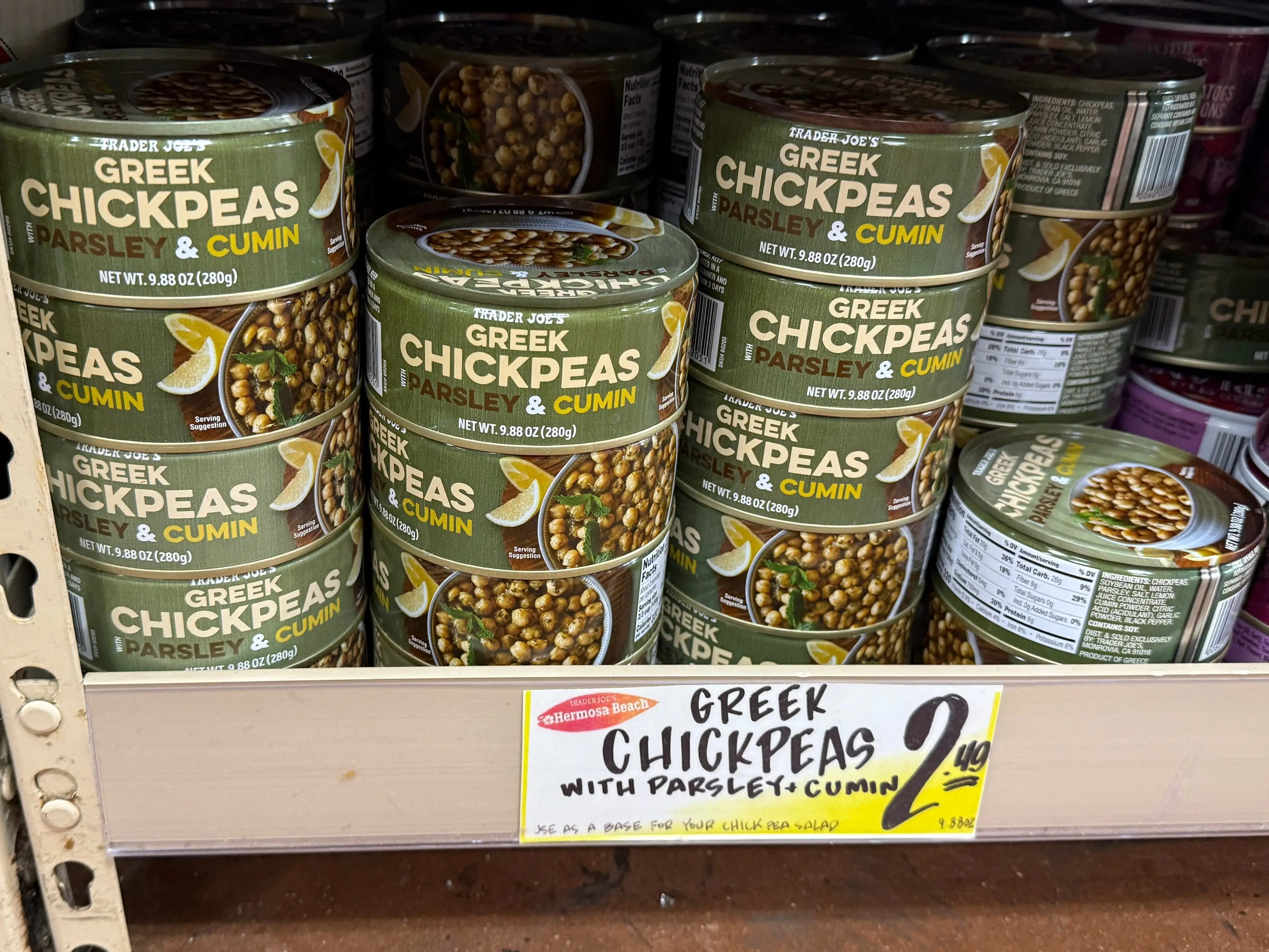 cans of greek chickpeas on the shelves at trader joe's