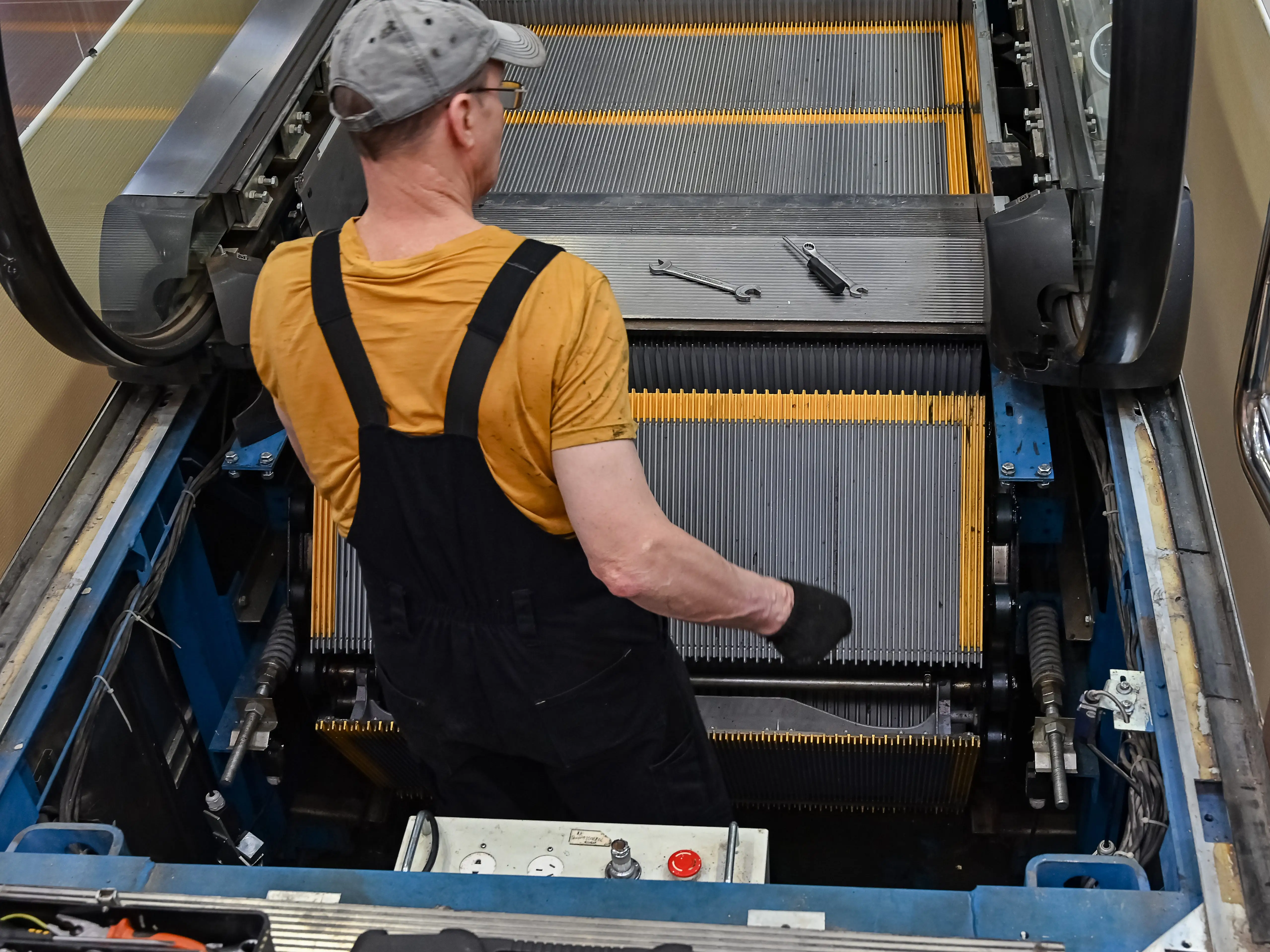Worker repairing escalator